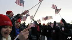 Spectators wave American flags on the National Mall in Washington, Jan. 21, 2013, before the start of President Barack Obama's ceremonial swearing-in ceremony during the 57th Presidential Inauguration.