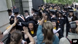FILE - Friends and family greet a procession of students in the graduating class of 2012 at Princeton University on June 5, 2012. 