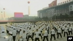 In this image made from KRT footage distributed by APTN, participants perform during a huge military parade marking the 65th anniversary of the founding of North Korea's Workers' Party, Sunday, Oct. 10, 2010, in Pyongyang.