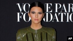 Kendall Jenner poses as she arrives to attend the Vogue party, in Paris, Wednesday July 9, 2014. (AP Photo/Thibault Camus)