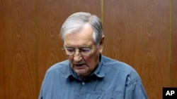 In this Nov. 9, 2013 released by the Korean Central News Agency, U.S. citizen Merrill Newman, 85, reads a document, which North Korean authorities say was an apology that Newman wrote and read in North Korea.