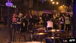 Rescue workers and medics work by victims in a Paris restaurant, Nov. 13, 2015. 