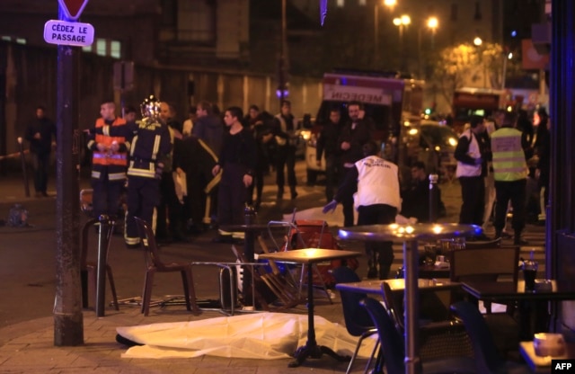 Rescue workers and medics work by victims in a Paris restaurant, Nov. 13, 2015.