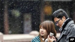 A couple visit snowy Yuyan Garden, one of the most popular tourist destinations in town, in Shanghai, China, Dec. 15, 2010.