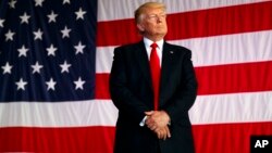 FILE - President Donald Trump is introduced to speak to U.S. military troops at Naval Air Station Sigonella, Italy.