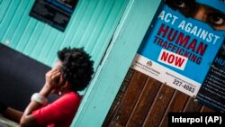FILE - A prostitute is shown being questioned during a raid in night clubs in Georgetown, Guyana, April 7, 2018. 