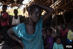 Charity Awate, 35, listens to instructions from refugee officials in a dilapidated church near Aba, Democratic Republic of Congo after fleeing fighting in South Sudan, on Dec. 19, 2017.