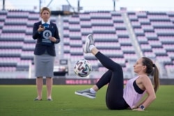 Laura Biondo, 32, from Venezuela, breaks the new Guinness World Record for "Most sit-down football crossovers in 30 seconds (female)" in Fort Lauderdale, Florida, U.S., in this undated handout photo. (Courtesy of Guinness World Records 2021/Juan Zabala)