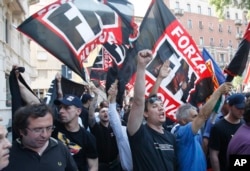 FILE - Forza Nuova extreme right-wing party activists shout slogans during a demonstration in Milan, Italy, May 22 , 2010.