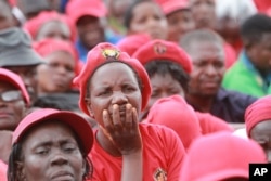 Zimbabwean Movement for Democratic Change supporters gather to pay their last respects during the burial of former leader Morgan Tsvangirai in Buhera, Zimbabwe, about 200 kilometers southeast of Harare, Feb, 20. 2018.