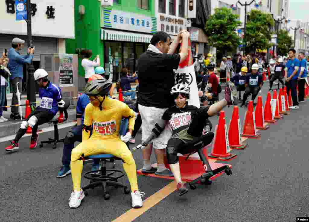 A racer crushes during the office chair race ISU-1 Grand Prix series, in Hanyu, north of Tokyo, Japan.