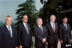 FILE: From left to right : Kieu Samphan, leader of the pro-Chinese Red Khmers, Son Sann, leader of the Nationalist party, Prince Norodom Sihanouk, leader of the Cambodian resistance, Roland Dumas, French Minister of Foreign Affairs, and Hun Sen, Prime Minister of the Phnom Penh government, pose before starting round table talks on July 25, 1989 in La Celle Saint Cloud, France. From July 30 to August 30, 1989, representatives of 18 countries, the four Cambodian parties, and the UN Secretary General met in Paris in an effort to negotiate a comprehensive settlement : withdrawal of the remaining Vietnamese occupation troops and genuine self-determination for the Cambodian people.
