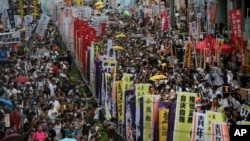 Hundreds of protesters march during an annual pro-democracy protest in Hong Kong, Friday, July 1, 2016