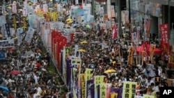 Hundreds of protesters march during an annual pro-democracy protest in Hong Kong, Friday, July 1, 2016