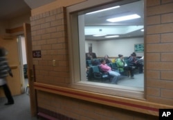 People sit in the waiting room of the Indian Health Service clinic in Crow Agency, Mont., Oct. 16, 2008. The Indian Health Service system serves almost 2 million American Indians in 36 states.