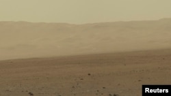 FILE - This color image taken August 8, 2012 from NASA's Curiosity rover, and released August 13, shows part of the wall of Gale Crater, the location on Mars where the rover landed on August 5, 2012.