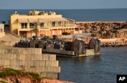 FILE - A U.S. amphibious hovercraft prepares to depart with evacuees from Janzur, west of Tripoli, Libya, April 7, 2019.