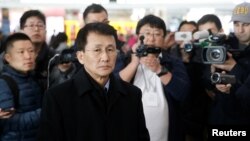 North Korean diplomat Choe Kang Il, center, waits at Capital International Airport to check in to a flight to Helsinki in Beijing, March 18, 2018.