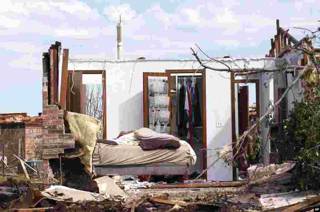 A tornado-damaged bedroom with clothes hanging in the closet is pictured in Oklahoma City, Oklahoma May 22, 2013.