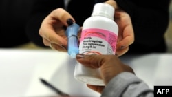 FILE - A mother gets antiretroviral drugs at the Chris Hani Baragwanath Hospital in Soweto, South Africa on May 16, 2012.