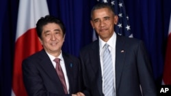 FILE - .S. President Barack Obama, right, and Japan's Prime Minister Shinzo Abe, left, shake hands during a bilateral meeting.