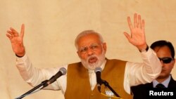 India's Prime Minister Narendra Modi addresses his supporters during a campaign meeting ahead of Gujarat state assembly election in Kalol on the outskirts of Ahmedabad, India, Dec. 8, 2017.