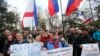 Pro-Russia demonstrators hold Russian and Crimean flags and posters as they rally in front of the local parliament building in Crimea's capital Simferopol, Ukraine, March 6, 2014.