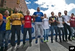 University students protest against President Nicolas Maduro in Caracas, Venezuela, Thursday, Nov. 3, 2016.