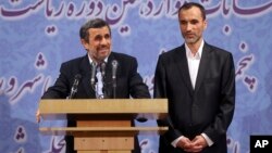 Former Iranian President Mahmoud Ahmadinejad, left, and his close ally Hamid Baghaei attend a press conference after registering his candidacy for the upcoming presidential election, at the election headquarters of the interior ministry, in Tehran, Iran, 