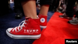 FILE - A supporter of Donald Trump wears a slogan on his sneakers as he attends opening of the Republican National Convention in Cleveland, Ohio, U.S., July 18, 2016. 