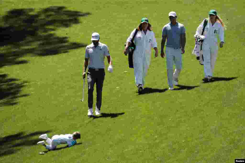 Dustin Johnson&#39;s son Tatum rolls down the hill as he joins his father during the 2019 Masters golf tournament&#39;s par 3 contest at the Augusta National Golf Club in Augusta, Georgia, April 10, 2019.