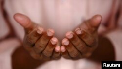 The hands of a Muslim man are seen as he offers prayers during the holy fasting month of Ramadan.