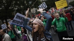 Protesters shout slogans during a demonstration against cuts in public education, in central Madrid, September 27, 2012.