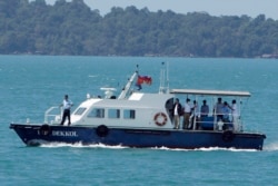A speed boat transports samples from some passengers who have reported stomachaches or fever, in the Westerdam anchored off Sihanoukville, Cambodia, Thursday, Feb. 13, 2020.