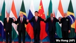 From left, Brazil's President Michel Temer, Russian President Vladimir Putin, Chinese President Xi Jinping, South Africa's President Jacob Zuma and Indian Prime Minister Narendra Modi pose for a group photo during the BRICS Summit at the Xiamen International Conference and Exhibition Center in Xiamen, southeastern China's Fujian Province, Sept. 4, 2017. 
