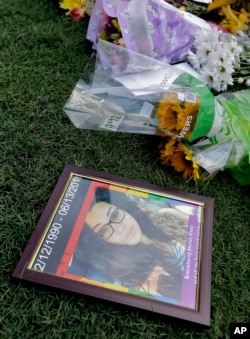 A photo of Amanda Alvear, one of the victims in the fatal shooting at the Pulse Orlando nightclub, lies at a makeshift memorial in Orlando, Fla., June 13, 2016.