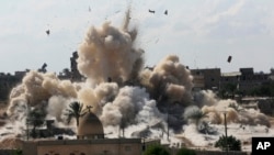 FILE - Smoke rises after Egyptian army demolished houses on the Egyptian side on border town of Rafah, Oct. 29, 2014. Human Rights Watch accused, May 28, 2019, security forces of committing widespread abuses against civilians in the Sinai Peninsula.