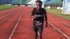 Idrissa Kargbo gets ready to run at the National Stadium, Freetown, Sierra Leone, Oct. 21, 2013 (N.deVries for VOA).