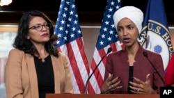 FILE - In this July 15, 2019, file photo, U.S. Rep. Ilhan Omar, D-Minn, right, speaks, as U.S. Rep. Rashida Tlaib, D-Mich. listens, during a news conference at the Capitol in Washington.(AP Photo/J. Scott Applewhite, File)