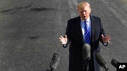 President Donald Trump talks with reporters as he departs from the South Lawn of the White House via Marine One in Washington, Dec. 16, 2017, to spend the weekend at the presidential retreat at Camp David in Maryland.