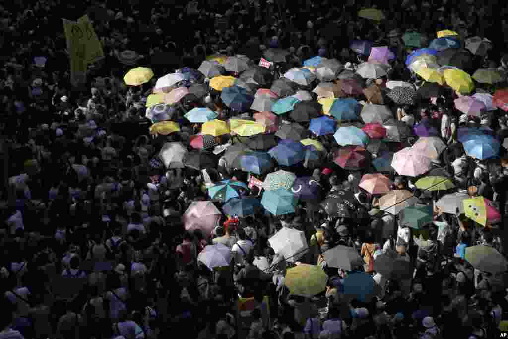 Protesters attend a rally to support young activists Joshua Wong, Nathan Law and Alex Chow in downtown Hong Kong.