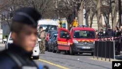 French police officers take position after letter bomb exploded at the French office of the International Monetary Fund, lightly injuring one person, March 16, 2017. 
