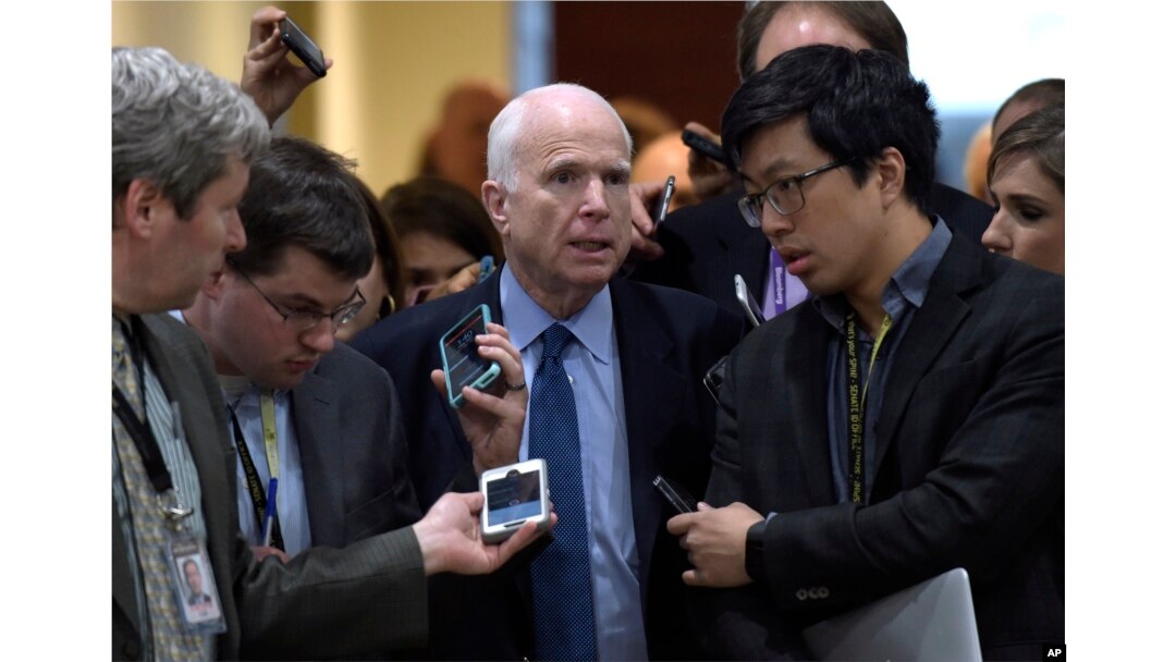 Sen. John McCain, R-Ariz., center, speaks to reporters following a briefing on Syria on Capitol Hill in Washington, April 7, 2017.