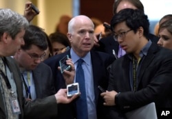 Sen. John McCain, R-Ariz., center, speaks to reporters following a briefing on Syria on Capitol Hill in Washington, April 7, 2017.