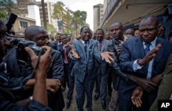 FILE - Opposition leader Raila Odinga gestures as he arrives at the Supreme Court in downtown Nairobi, Kenya, Sept. 1, 2017.