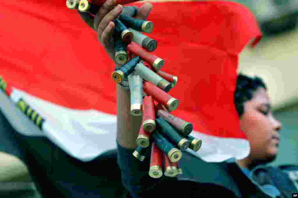 A protester displays used shotgun shells he said were used in recent clashes in Tahrir Square, during events to mark the second anniversary of former President Hosni Mubarak&#39;s resignation, February 11, 2013. 