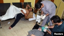 People, affected by what activists say is nerve gas, are treated at a hospital in the Duma neighborhood of Damascus August 21, 2013. 