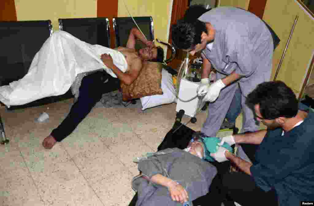 People, affected by what activists say is toxic gas, are treated at a hospital in the Duma neighborhood of Damascus August 21, 2013. 