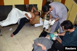 People, affected by what activists say is nerve gas, are treated at a hospital in the Duma neighborhood of Damascus, Aug. 21, 2013.