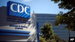 FILE - In this Oct. 8, 2013, file photo, a sign marks the entrance to the federal Centers for Disease Control and Prevention, in Atlanta, Georgia.